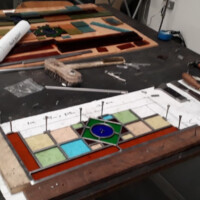 Stained glass window being repaired in workshop Stained glass window being repaired in workshop